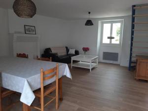 a living room with a table and a couch at Gite de la paludière in Assérac