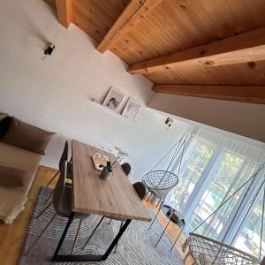 a living room with a wooden table and chairs at Vikendica Farah in Gaj