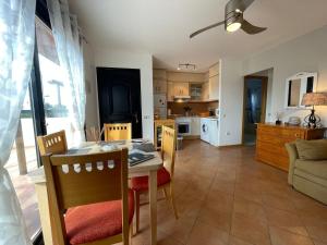 a kitchen and living room with a table and chairs at Adam Home Origo Mare in Lajares