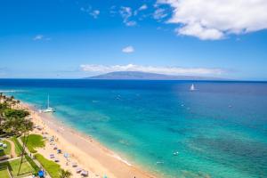 a view of a beach with a boat in the water at The Whaler Resort in Lahaina