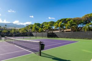 a tennis court with two people playing tennis at The Whaler Resort in Lahaina