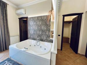 a bathroom with a bath tub in a room at Casa Aieddu in Terrasini