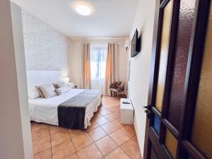 a hotel room with a bed and a window at Casa Aieddu in Terrasini