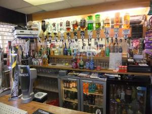 a bar with a lot of bottles on the wall at Charnley Gold in Blackpool