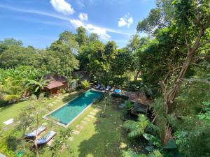 an aerial view of a backyard with a swimming pool at Mahamustika Riverside in Canggu