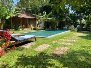 a swimming pool in the yard of a house at Mahamustika Riverside in Canggu