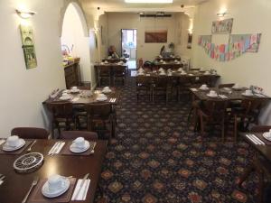 a dining room with wooden tables and chairs at Charnley Gold in Blackpool