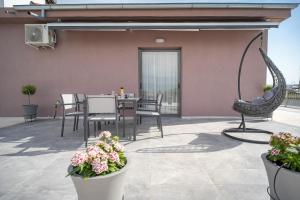 a patio with a table and chairs and a swing at Central Palace Trikala in Tríkala