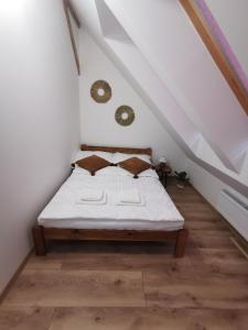 a bedroom with a bed in a attic at Harmony Apartment in Ostróda