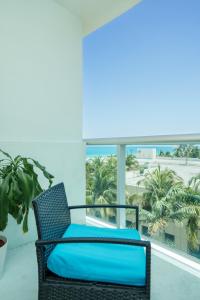 a chair on a balcony with a view of the beach at Modern 1 BDR Oceanview with direct beach access! in Hollywood