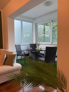 a living room with a couch and a table and chairs at Tranquil verde in Matulji +5 photos