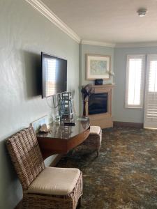 坎布里亞的住宿－藍海豚酒店，客厅配有桌椅和电视。