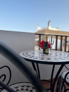 una mesa con una botella de vino y una copa en Tenerife Island Oasis Apartment en El Guincho