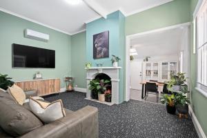 a living room with a couch and a fireplace at Amelia Terrace - House in Brisbane City Central in Brisbane