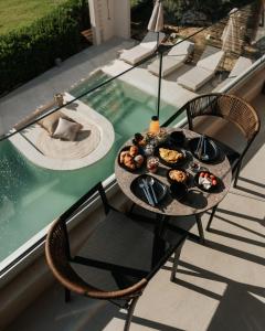 a tray of food on a table next to a swimming pool at AMÉNTE Mindful Stay in Plakias