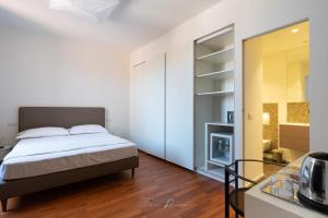a bedroom with a bed and a glass table at Affittacamere Al campanile in Sarzana