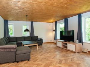 a living room with a couch and a flat screen tv at Holiday home Rømø XVII in Rømø Kirkeby