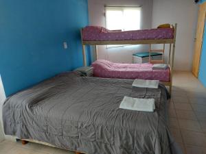 a bedroom with two bunk beds in a room at MAPU PATAGONIA in Puerto Madryn