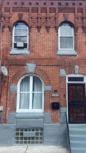 a brick building with two windows and a door at Feel at home when you’re away in Philadelphia