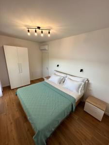 a bedroom with a large bed with a green blanket at Dream View Villa in Jadranovo +44 photos