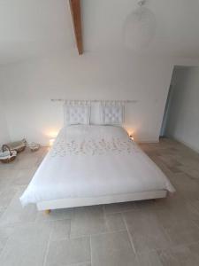 - une chambre avec un lit blanc et des draps blancs dans l'établissement Maison de charme proche Bastia, à Prunelli-di-Casacconi