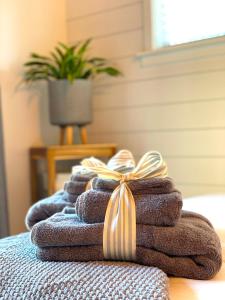 a pile of towels with a bow on top at Private Wine Country-River Bungalow! Sunny Treetop Views - Pets Stay Free in Forestville