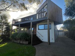 a house with a staircase and a balcony at Coastal Beauty on Bruce in Inverloch