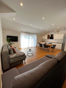 a living room with a couch and a table at Dream View Villa in Jadranovo