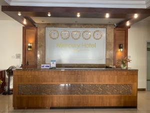 a hotel lobby with a reception desk and a merry hotel sign at Mercury Hotel & Apartment in Vung Tau