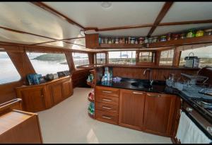 a kitchen with wooden cabinets and a sink in a boat at Göcek Bays and Islands in Fethiye