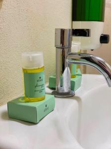 a bathroom sink with a bottle of moisturizing moisturizing soap at Hotel La Capilla - Suites & Apartments San Benito in San Salvador +45 photos