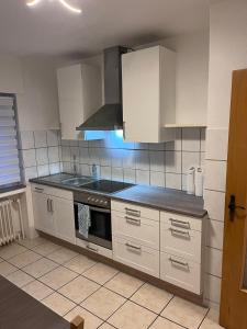a kitchen with white cabinets and a sink at Bocholt Apartment Ferienwohnung 3 in Bocholt