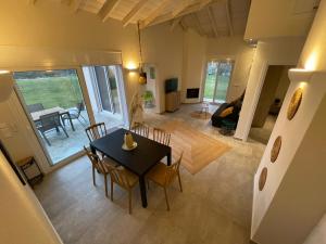 a dining room and living room with a table and chairs at Villanet SeaView Halkidiki in Mola Kalyva