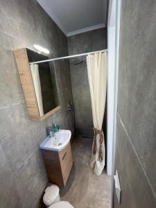 a bathroom with a sink and a toilet and a mirror at Villanet SeaView Halkidiki in Mola Kalyva +22 photos