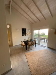 a dining room with a table and chairs and a large window at Villanet SeaView Halkidiki in Mola Kalyva