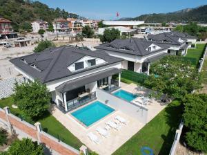 an aerial view of a house with a swimming pool at HACI BEY VİLLALARI in Kemer