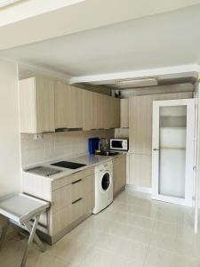 a kitchen with a washer and dryer in it at Hiruanaiek puerto Bermeo in Bermeo