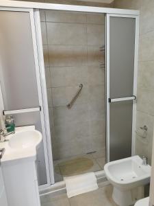 a bathroom with a shower and a toilet and a sink at CAPi I in Corrientes