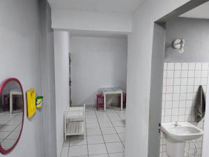 a bathroom with a sink and a toilet at Ed Bertholi - Vista lateral do mar com garagem in Serra