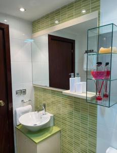y baño con lavabo y espejo. en Apartamento Con Vistas Al Pilar con Aparcamiento privado en Zaragoza