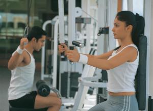 a man and a woman exercising in a gym at The Oberoi Bengaluru in Bangalore