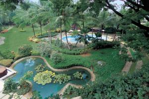 an aerial view of a garden with a swimming pool at The Oberoi Bengaluru in Bengaluru
