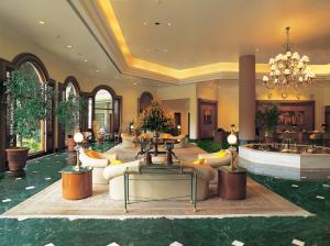 a lobby with couches and tables and a chandelier at The Oberoi Bengaluru in Bangalore