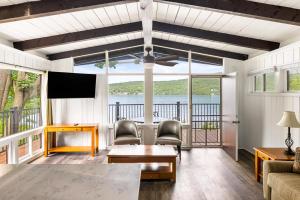 a living room with a view of the water at Sun Castle Resort in Lake George