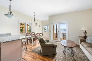 a kitchen and living room with a table and chairs at Sun Castle Resort in Lake George