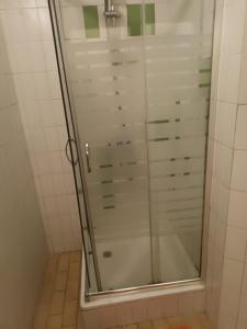 a shower with a glass door in a bathroom at City Drops Hostel Clérigos Private Room in Porto