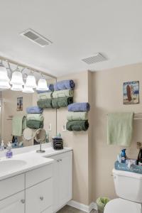 a bathroom with a sink and a toilet and a mirror at Town of Dewey Beach - 100 Collins Ave, Unit #103 in Dewey Beach
