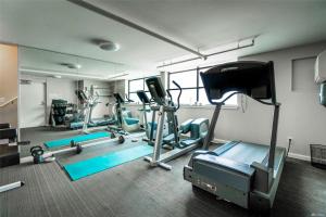 a gym with several tread machines and a mirror at 1BR Condo, Air Conditioning, FREE Parking, Rooftop View in Seattle