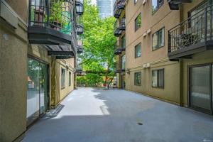 an empty alley between two buildings in a city at 1BR Condo, Air Conditioning, FREE Parking, Rooftop View in Seattle