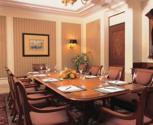 a conference room with a long table and chairs at The Oberoi Bengaluru in Bengaluru